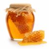 Pure Forest Honey Jar Glass jar of pure forest honey with natural honeycomb isolated on a white background.