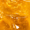Rich Golden Honey Texture Close-up view of pure forest honey displaying its rich golden color, smooth consistency, and natural glossy texture.