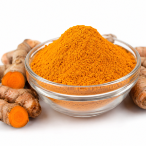 Fresh organic turmeric powder in a clear glass bowl isolated on a clean white background.