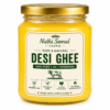Premium Pure Cow Ghee Glass Jar Premium pure cow ghee in a transparent glass jar with a rich golden appearance on a white background