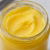 Rich Creamy Pure Cow Ghee Close-up view of premium pure cow ghee highlighting its rich creamy texture in a glass jar
