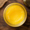 Pure Cow Ghee Top View Top view of premium pure cow ghee in a glass jar showcasing its rich golden color and natural purity